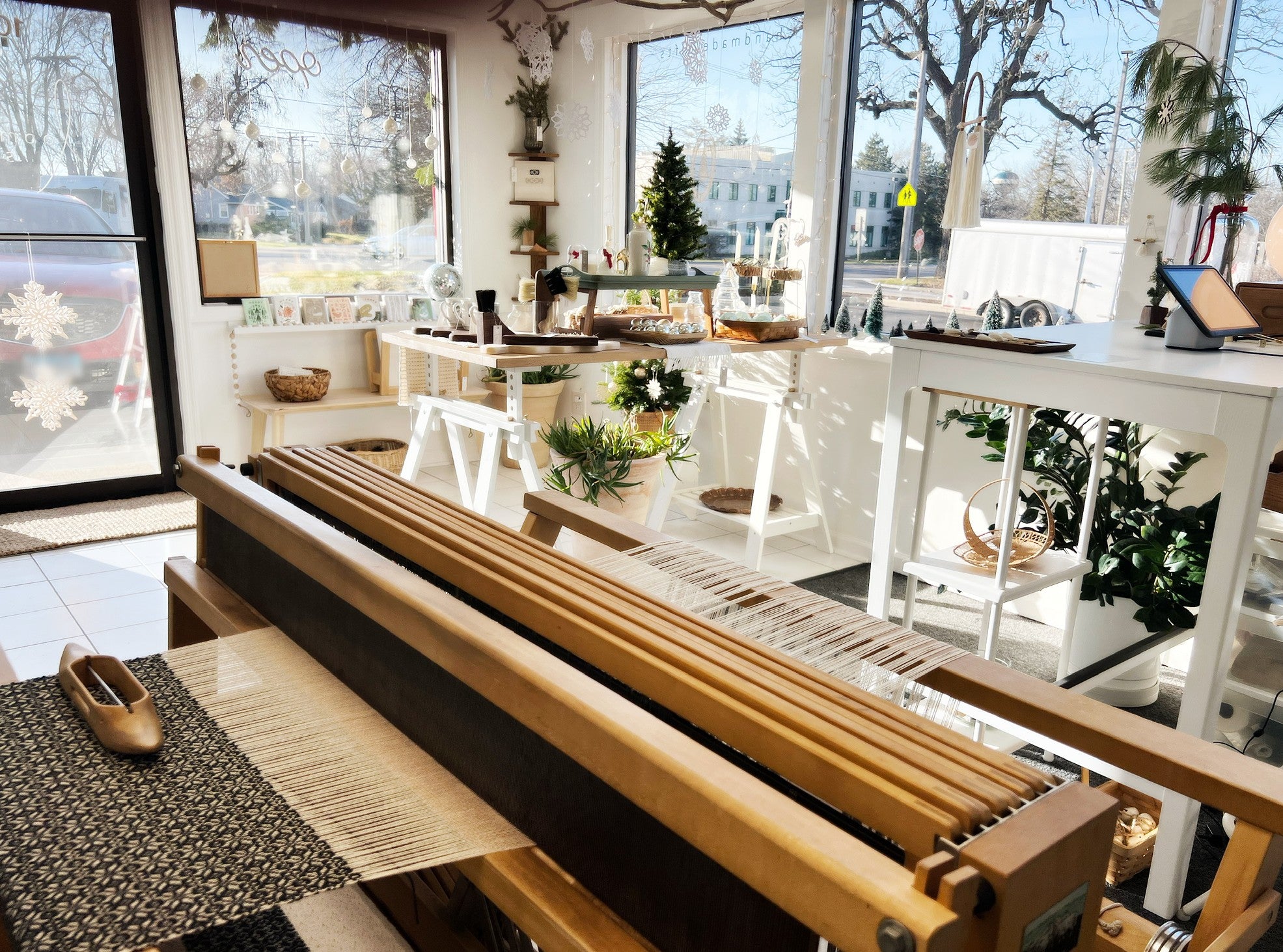 Interior of Loomi Shop showing products and a working loom.